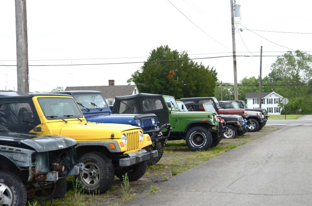 A row of jeeps parked outside.