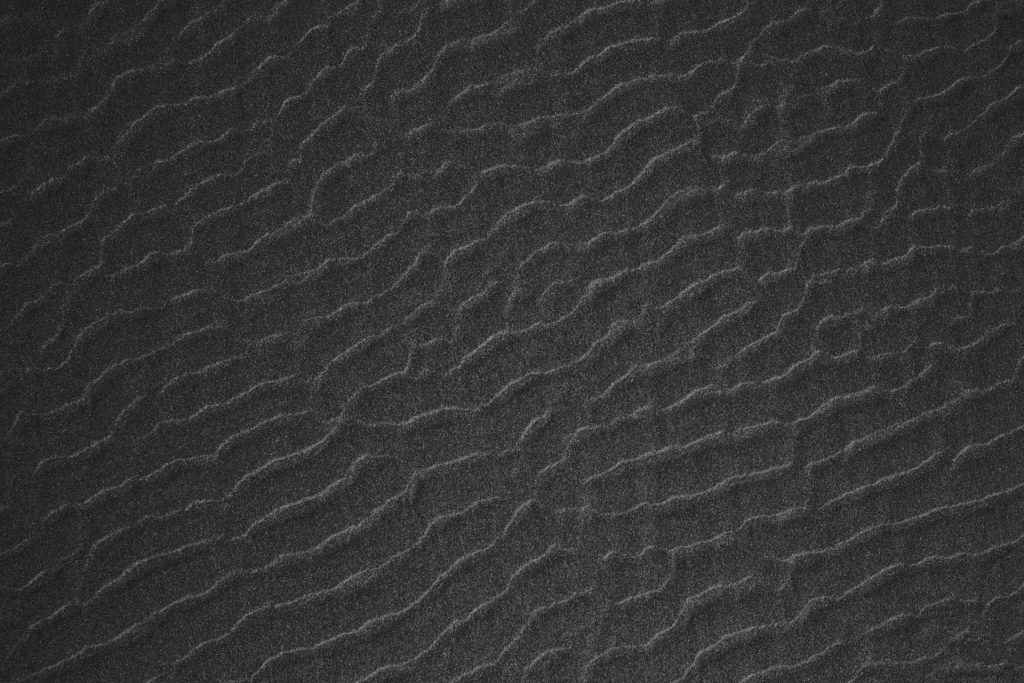 a black and white photo of a textured surface